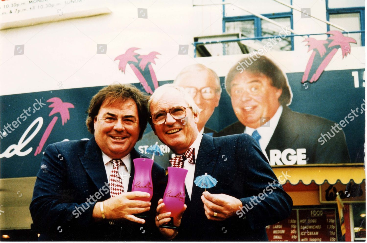 eddie-large-and-syd-little-with-pink-cocktail-glasses-in-front-of-the-paradise-room-at-blackpool-pleasure-beach-1995-shutterstock-editorial-3081691a.jpg